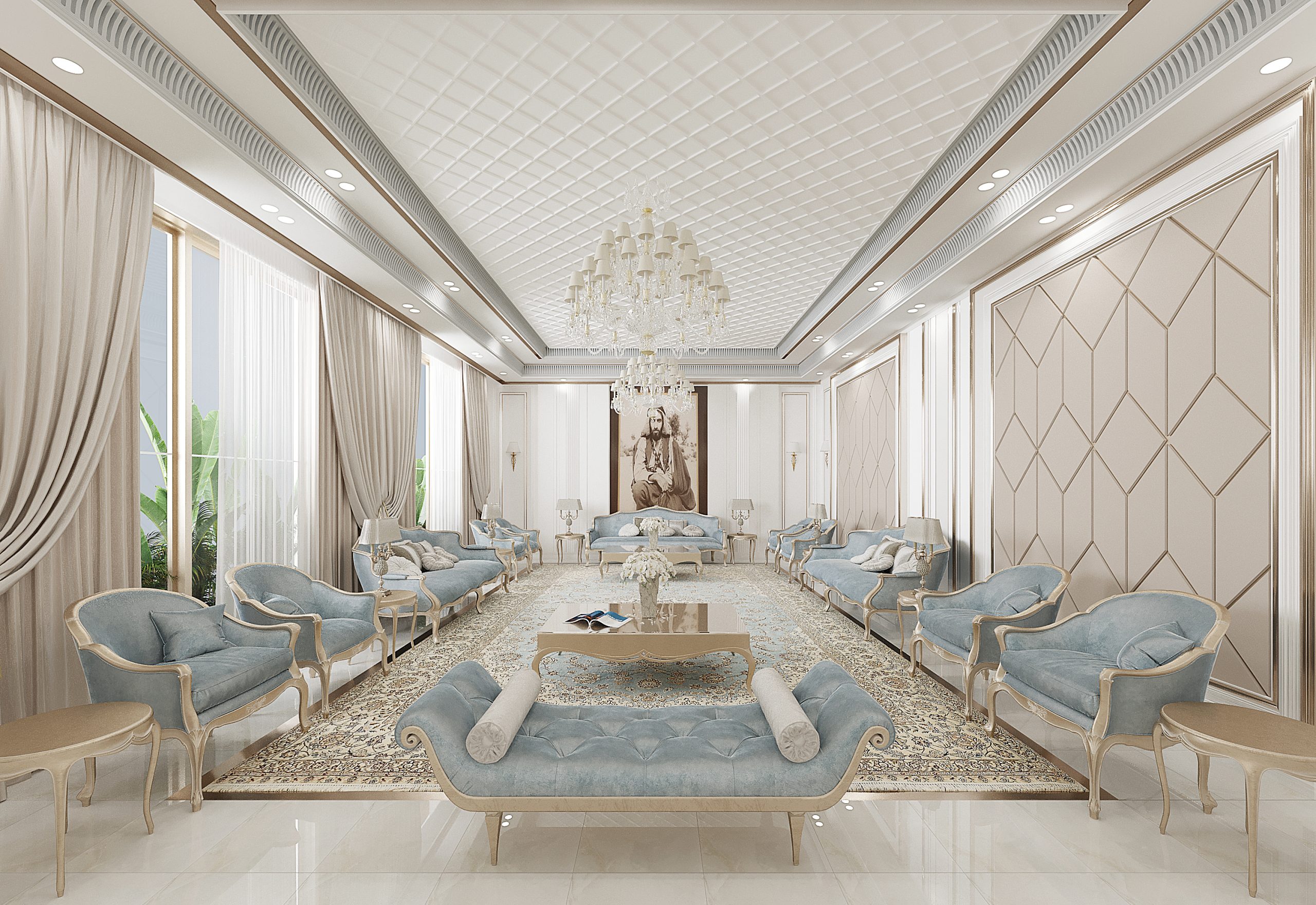 Luxurious majlis interior with an elegant and symmetrical layout featuring pastel blue tufted seating, cream and gold detailing, and a long ornate rug anchoring the space. A large crystal chandelier hangs from a quilted ceiling, while sheer curtains frame tall windows, and a regal portrait adds a focal point of SHEIKH ZAYED at the far end of the room